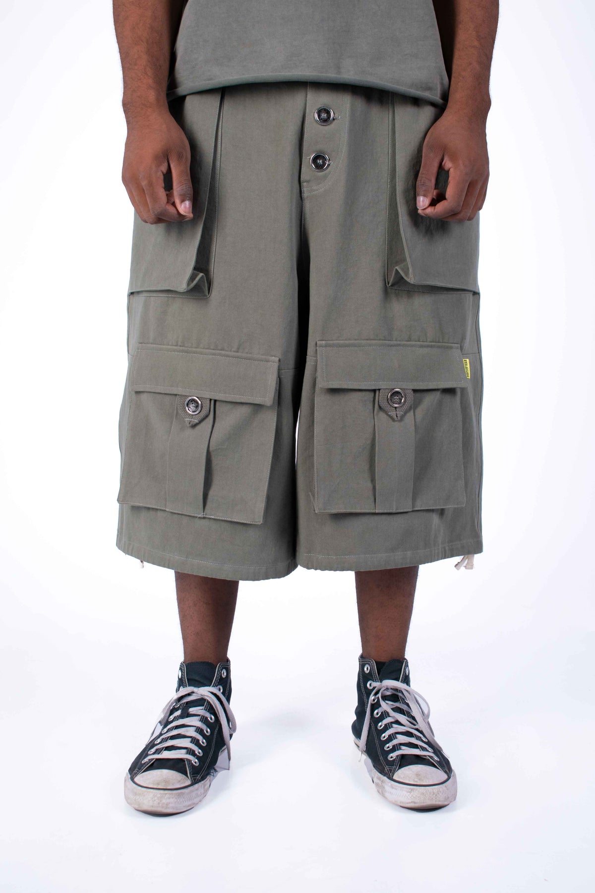 Military green utility cargo shorts pocket detail